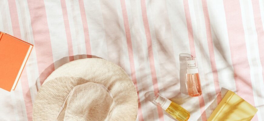 Summer,Pastel,Background,With,Wide-brimmed,Sun,Hat,,Cosmetics,Products,,Book