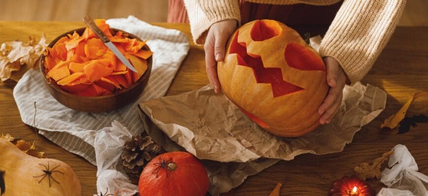 Carving,Halloween,Pumpkin.,Woman,Holding,Pumpkin,And,Knife,On,Table